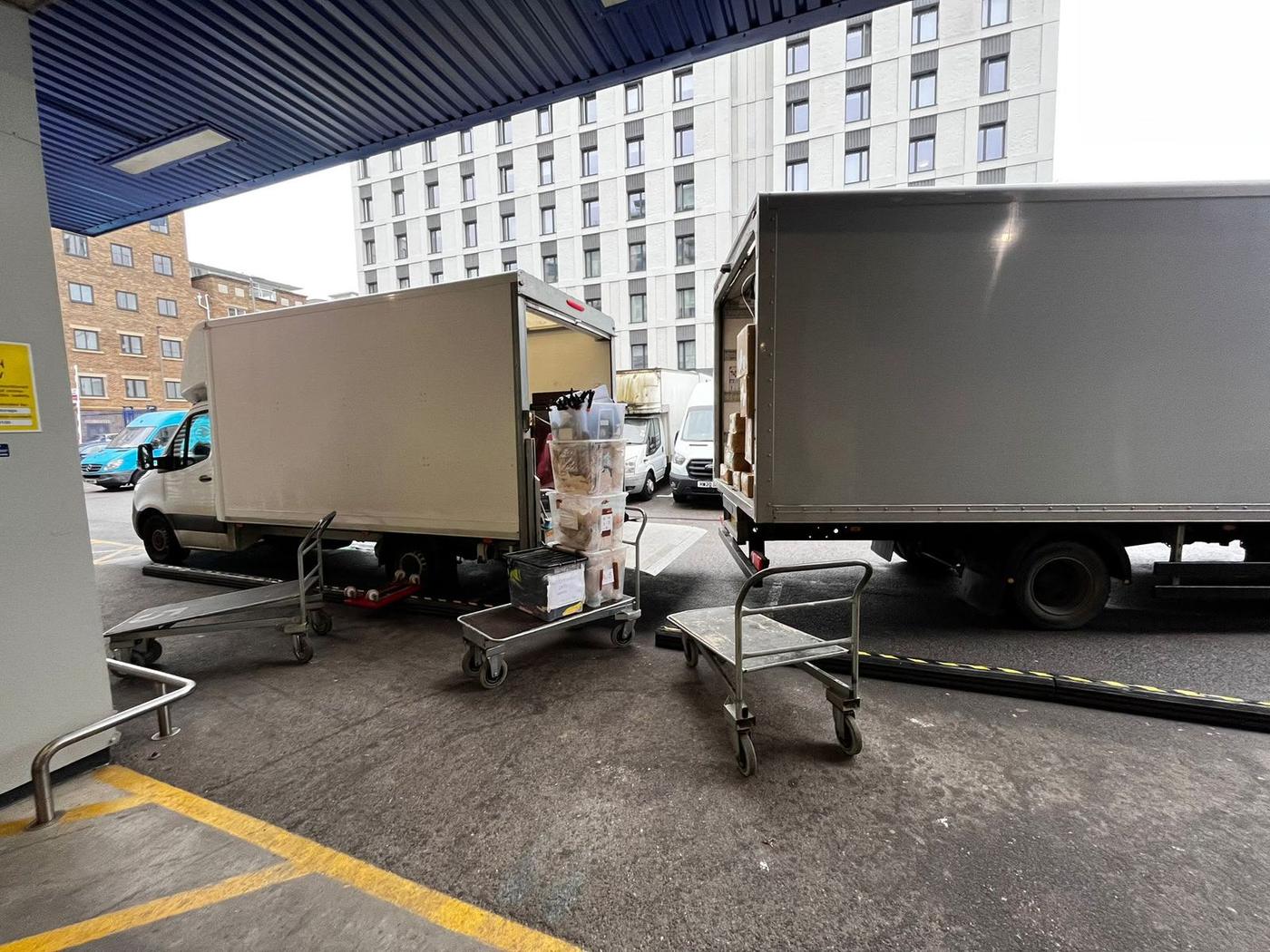 A Fastiya Logistics lorry and Luton van loading at a London loading bay
