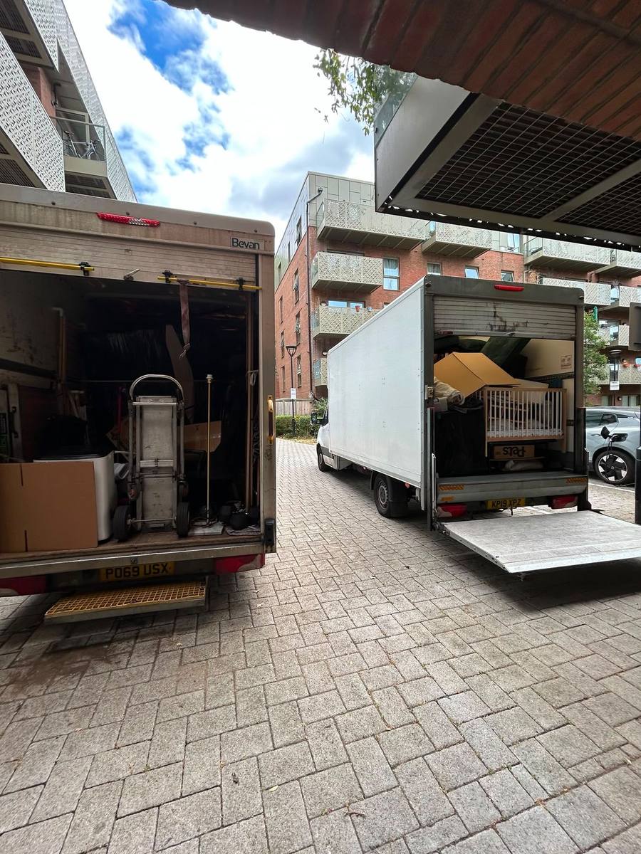 Two Fastiya Logistics vans with tail lifts down at a London development
